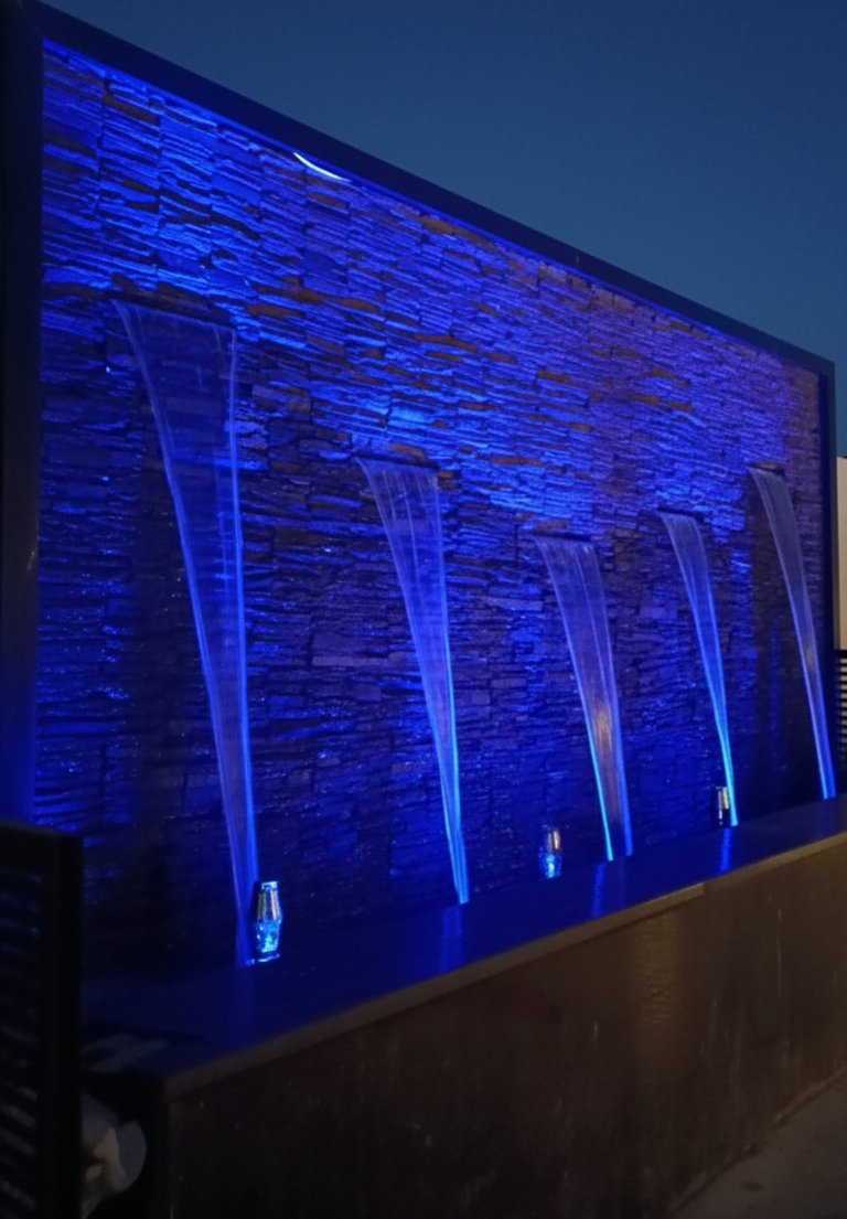 Illuminated blue waterfall wall — Mehrauli, New Delhi